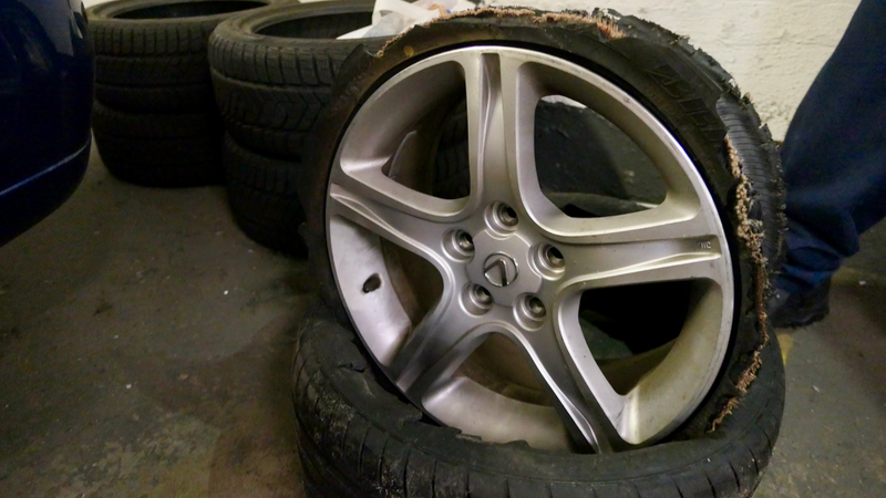 The shredded tire after I got home, with the wheel atop it. If you notice, the tire is still technically attached to the wheel. Well, a small part of it is.